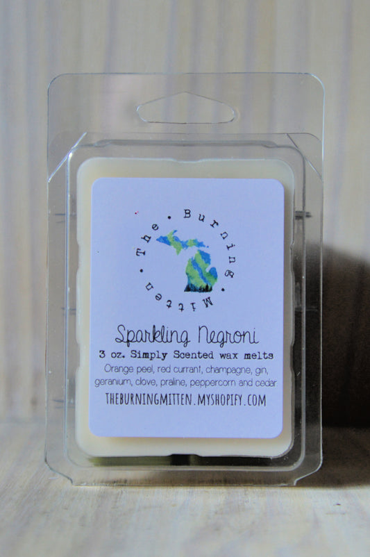 Sparkling Negroni Simply Scented Clamshell (orange peel, red currant, champagne, gin, geranium, clove, praline, peppercorn and cedar)