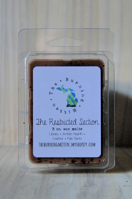 The Restricted Section Clamshell (library + amber hearth + leather + palo santo)